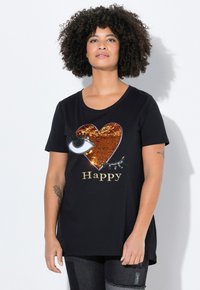 Musta puuvillapaita, jossa on paljeteilla koristeltu sydäntasuunnittelu, silmä ja sana "Happy" kultaisella kirjaimilla. Lyhyet hihat, rento malli.