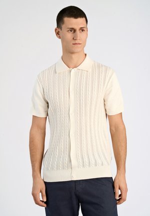 Short-sleeve knitted cardigan in cream, featuring cable-knit texture, button-down front, and a classic collar design.