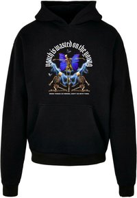 Črna kapuca s grafiko okostnjaka, modrimi metulji, motivi strel in besedilom "Mladost je zapravljena za mlade."
