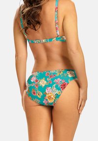 Kwiatowy bikini w odcieniu turkusu z intensywnym wzorem. Regulowane ramiączka i zapięcie z tyłu. Miękki, elastyczny materiał.