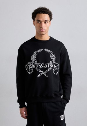 Black sweatshirt featuring a white graphic design with the word "MOSCHINO" and a laurel wreath. Made of soft fabric with a classic fit.