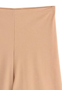 Leggings beiget, valmistettu sileästä ja joustavasta kankaasta. Ominaisuuksiin kuuluu korkea vyötärö ja saumaton muotoilu mukavuutta ja istuvuutta varten.