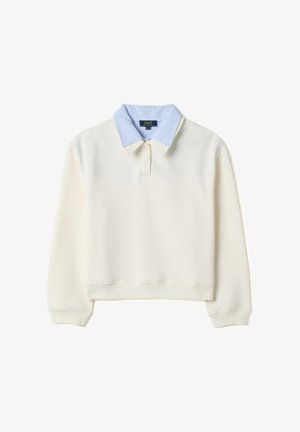 Felpa crema a maniche lunghe con una camicia a righe blu e bianche con colletto incorporata sotto, dotata di una linea con due bottoni.