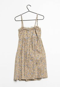 Kukkamekko ohuilla olkaimilla, vaaleanruskeasta kankaasta, pienillä sinisillä ja vihreillä kukkakuoseilla, kerätystä vyötäröstä ja polveen ulottuvasta helmasta.