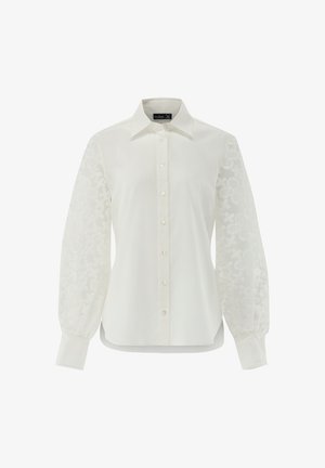 Weißes Hemd mit klassischem Kragen, voll-langen bestickten durchsichtigen Ärmeln und Knopfverschluss vorne. Sanfte Textur; leichter Glanz.
