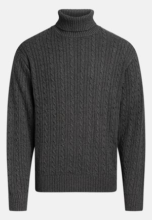 Tumehall roheline kootud kõrge kaelusega sviiter ribadega äärtel, millel on tekstiilne muster, mis kulgeb vertikaalselt mööda keha ja varrukate.