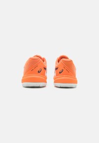Orange athletic shoes with mesh upper, cushioned sole, and white rubber outsole. Features branding on the sides and textured heel.