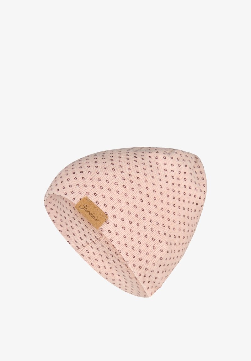 Light pink knit beanie with small dark dots pattern and a tan rectangular leather label stitched on the side.