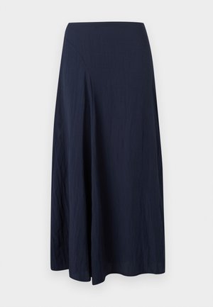 Tumesinine pahkluu pikkune seelik, millel on asümmeetriline õmblus ja pehmed voldid, valmistatud kergest tekstureeritud kangast.