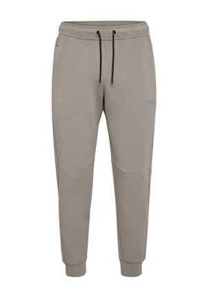 Grå mjukisbyxor med dragsko i midjan, avsmalnande ben och sömmar som accentuerar knäna. Gjorda av mjukt tyg med en broderad logotyp på låret.