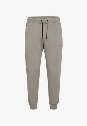 Grå mjukisbyxor med dragsko i midjan, avsmalnande ben och sömmar som accentuerar knäna. Gjorda av mjukt tyg med en broderad logotyp på låret.