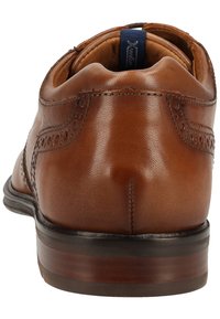 Braune Leder-Halbschuhe mit glatter Oberfläche, Brogue-Verzierungen, abgerundetem Zehenbereich und einer robusten Gummisohle. Verfügt über einen gepolsterten Schaft.