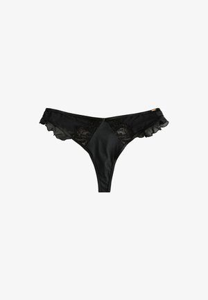 Braguitas tanga negras para mujer con paneles de encaje y bordes con volantes en los laterales, hechas de tela transparente y opaca.