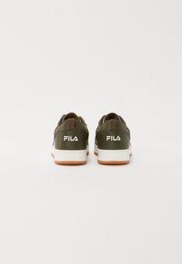 Green leather sneakers with white midsoles and brown rubber outsoles. Features a logo on the heel and a loop for easy pull-on.