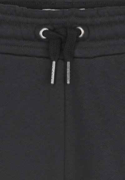 Zwarte joggingsbroek met een zachte textuur, elastische tailleband met een trekkoord en metalen oogjes in zilvertint. Eenvoudig ontwerp zonder patronen.