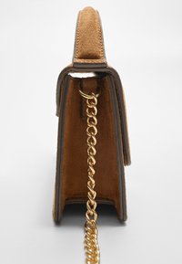 Brown suede handbag with a structured shape, gold chain strap, and contrasting leather trim. Features a smooth texture and clean lines.