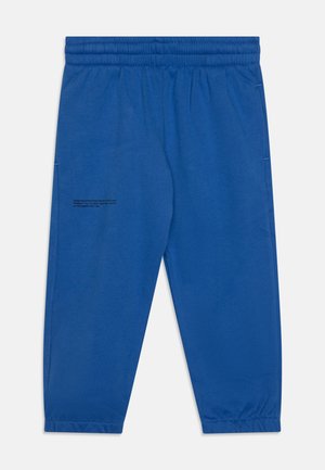 Blaue Jogginghose aus weichem Stoff, mit einem elastischen Bund, schmal zulaufenden Beinen und einem Druckdetail am linken Bein.