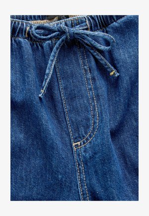 Shorts din denim cu talie elastică și șnur, având o buzunar frontal și cusături contrastante în bej deschis.