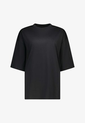 T-shirt noir oversize à manches courtes avec col rond, design uni, coupe ample, présenté sur fond blanc.