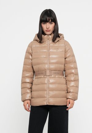 Beige pufferjack met een glanzende afwerking, met een capuchon, ritssluiting en een geplooide taille; bevat Calvin Klein branding op de riem.
