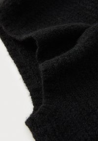 Black wool fabric with a soft, textured surface, displayed in a draped position showing its thick, fuzzy appearance and smooth outline.