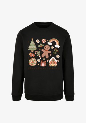 Sudadera negra con un gráfico colorido de temática navideña que incluye un árbol, un hombre de jengibre, caramelos y acentos festivos, etiquetado como "Vibras Navideñas".