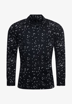Chemise noire à manches longues boutonnée avec un motif dispersé de petits carrés blancs et un col classique.