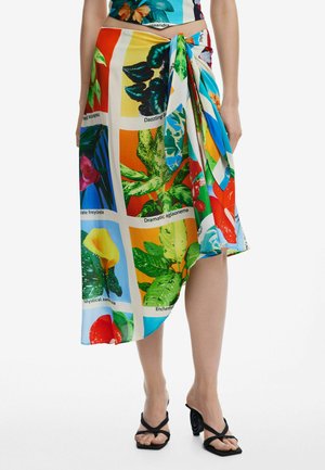 Floral-patterned wrap skirt in vibrant colors, featuring green leaves and flowers on a light background. Made from a lightweight fabric.