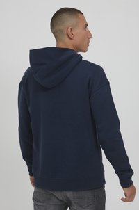 Navy blue hoodie with a drawstring hood, ribbed cuffs, and hem. Features a smooth fabric texture and standard fit design.