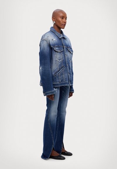 Denim jacket with two chest pockets, distressed details, and a relaxed fit. Paired with flared jeans featuring side slits and a light wash.