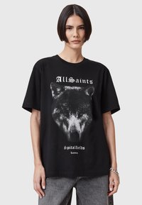 Musta puuvillapaita, jossa on väljä muotoilu. Etuosassa on graafinen painatus suden päästä ja valkoiset tekstit "AllSaints Spitalfields London".