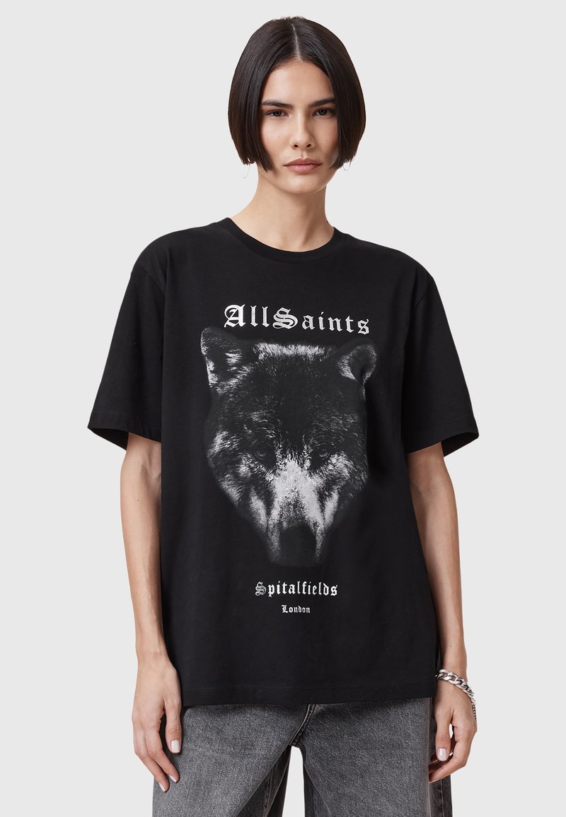Musta puuvillapaita, jossa on väljä muotoilu. Etuosassa on graafinen painatus suden päästä ja valkoiset tekstit "AllSaints Spitalfields London".