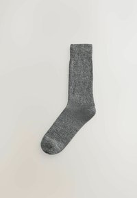 Gray sock with a textured knit pattern, featuring a ribbed cuff and a rounded toe. The material appears soft and flexible.