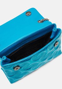Piccola borsa a tracolla in pelle blu con motivo a onde trapuntato, patta aperta, chiusure a scatto magnetico in argento e anello per la catena visibile.