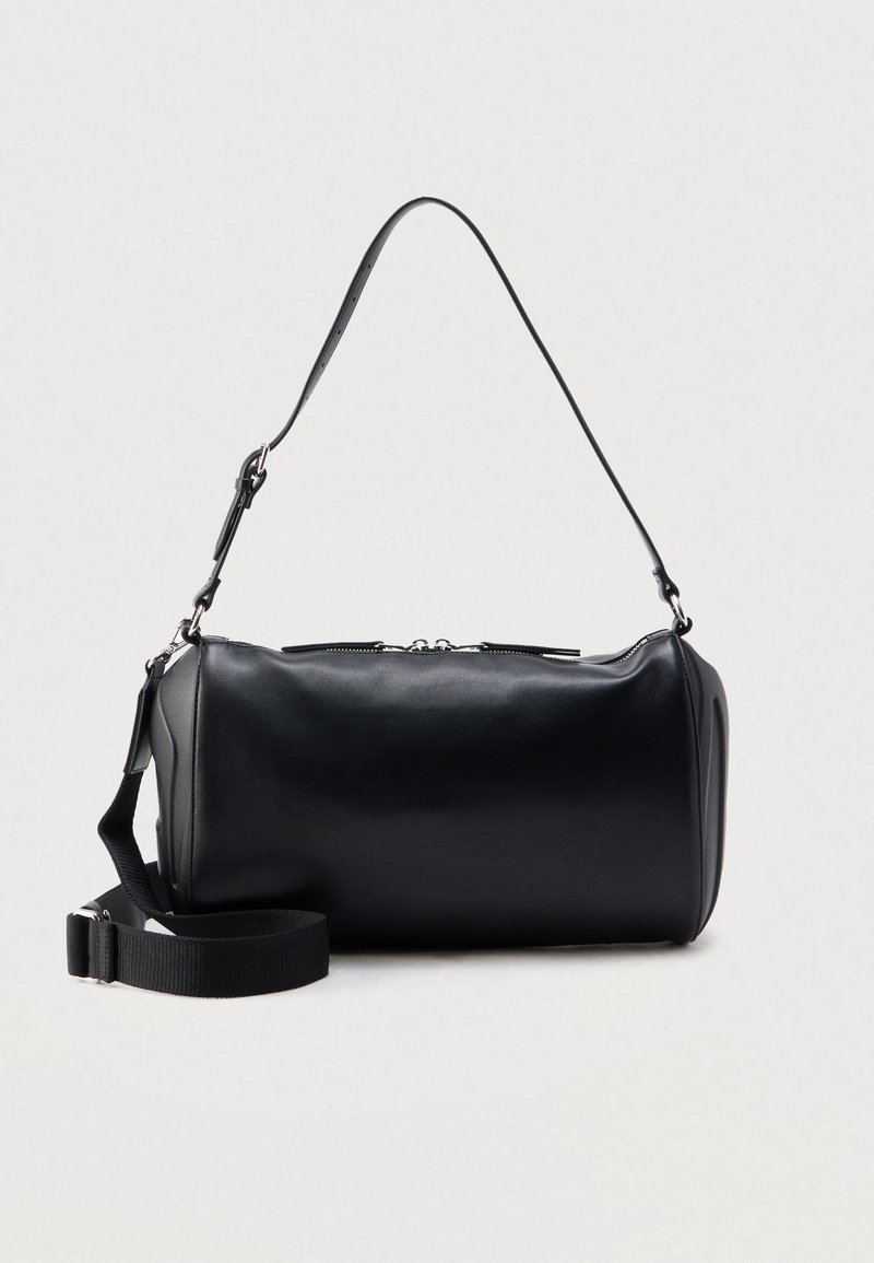 Black, smooth leather handbag with a cylindrical shape, featuring a single adjustable strap. Silver hardware and top zipper closure detail.