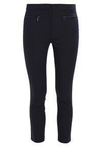 Svarta, åtsittande byxor i ett slätt tyg. Har två framfickor med dragkedja och ett midjehögt midjeband som ger en strömlinjeformad silhuett.