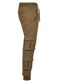 Brune bomull joggebukser med slim fit, med flere side cargo-lommer og elastiske mansjetter. Drawstring midje med en glatt tekstur.