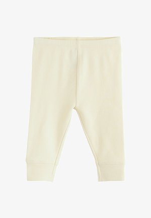 Leggings de culoare crem, cu un design strâmt și talie elastică. Marginile la pantaloni sunt îngustate, evidențiind o textură moale. Fără modele sau elemente de metal.