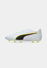 White soccer cleat featuring a black stripe, yellow and red accents, textured upper, and six yellow studs on a clear outsole.