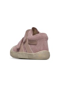 Pink suede children's shoe with Velcro strap, textured rubber sole, rounded back, and minimalistic design.