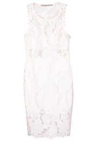 Robe blanche sans manches en dentelle longueur genou avec encolure ronde et garniture décorative à pompons sur les bretelles.