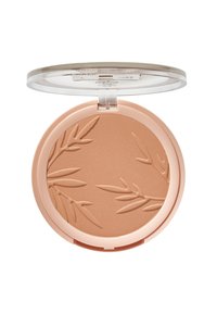 Bronzer en poudre pressée dans un compact rond, couleur brun clair avec un motif de feuille en relief. Couvercle transparent, texture douce et boîtier en plastique.