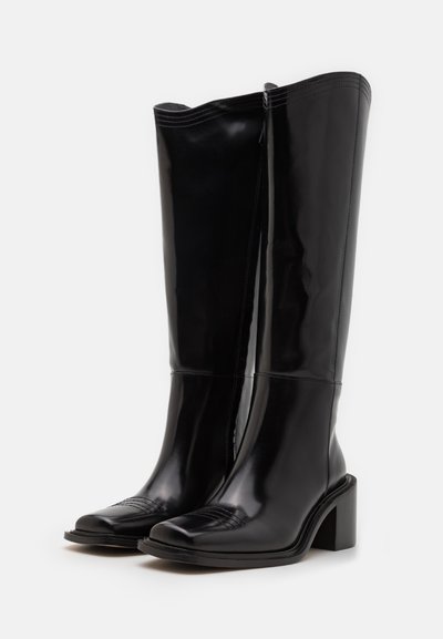 Black patent leather knee-high boots with a square toe, block heel, and vertical seams. Smooth texture with subtle horizontal accents on the toe.