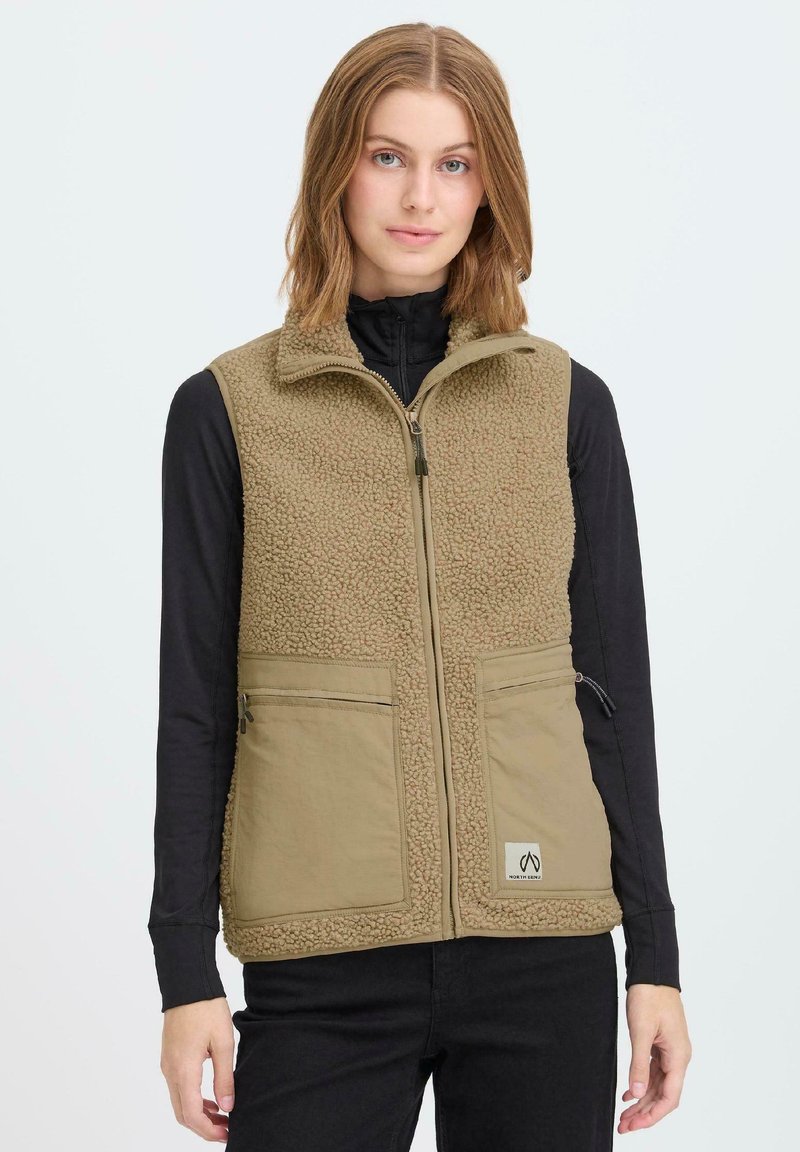 Khakifarbene Fleece-Weste mit hohem Kragen und zwei Fronttaschen; zeichnet sich durch eine weiche Textur und einen Reißverschluss vorne aus. Am unteren Rand beschnitten.