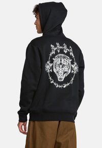 Black hoodie with a large white tiger graphic on the back, framed by barbed wire and roses, featuring a front kangaroo pocket.