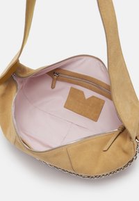 Beige suede handbag featuring a pink interior, silver zipper, and a chain accent along the bottom. Includes a small zippered pocket inside.