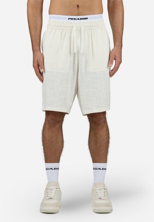 Hvite linshorts med elastisk midjebånd og snøring, med to frontlommer og en avslappet passform. Utsmykket med en logo på midjebåndet.