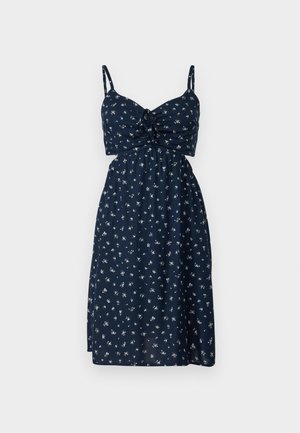 Navy blue floral dress with a fitted bodice, adjustable spaghetti straps, and a gathered waist, featuring small white flower patterns throughout.