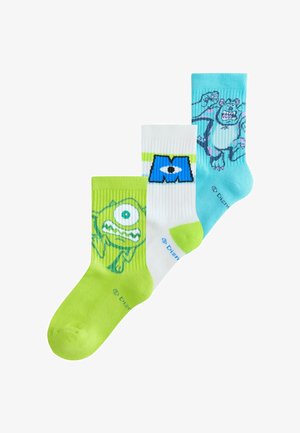 Drei bunte Socken mit Figuren aus Monsters, Inc.: grün mit Mike Wazowski, weiß mit blauem "M"-Augenlogo und blau mit Sulley.