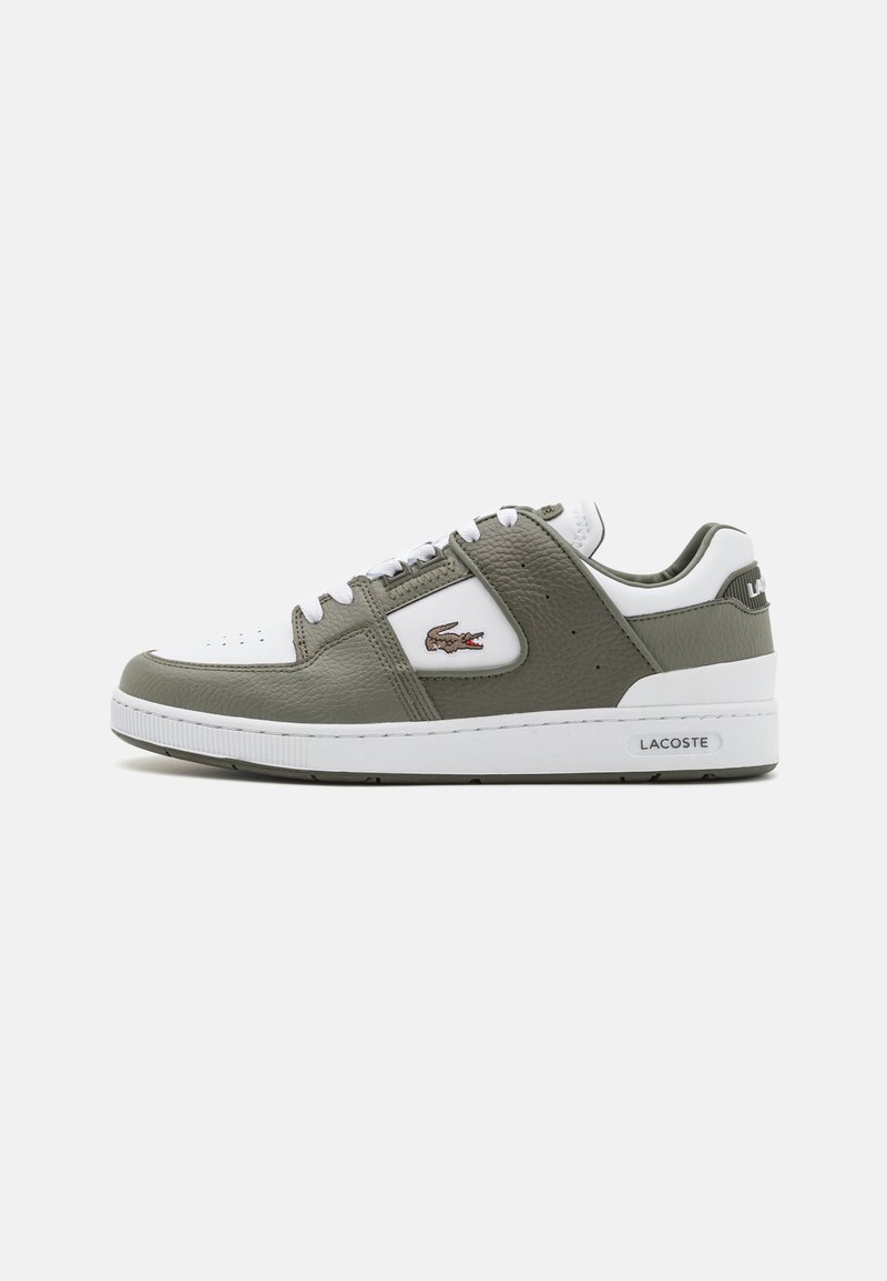 Lacoste sneaker featuring olive green leather upper, white accents, perforated detailing, and logo patch on the side. Rubber outsole.